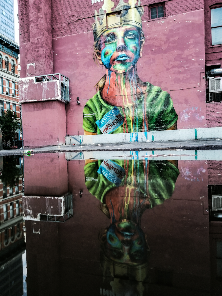 Colorful graffiti of a child wearing a crown and t-shirt on 16th Street